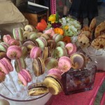 Colorful French macaron cookies on lollipop sticks by pastry chef Jennifer Costa-Stines of A.R. Valentien in La Jolla, Calif., wait on a pink metal dessert cart for Street Food Market partygoers, March 24, 2013. (Photo by Cyndia Zwahlen for the Small Biz Mix)