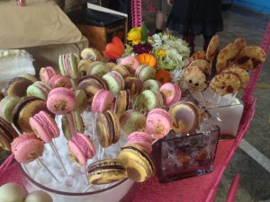 Colorful French macaron cookies on lollipop sticks by pastry chef Jennifer Costa-Stines of A.R. Valentien in La Jolla, Calif., wait on a pink metal dessert cart for Street Food Market partygoers, March 24, 2013. (Photo by Cyndia Zwahlen for the Small Biz Mix)