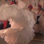 A spiral swirl of white ruffles is almost all there is to see of this Ballet Folklorico dancer from DanzArts of San Diego, one of the entertainers at the Street Food Market party held March 24, 2013 in the San Diego Public Market. (Photo by Cyndia Zwahlen for the Small Biz Mix.)